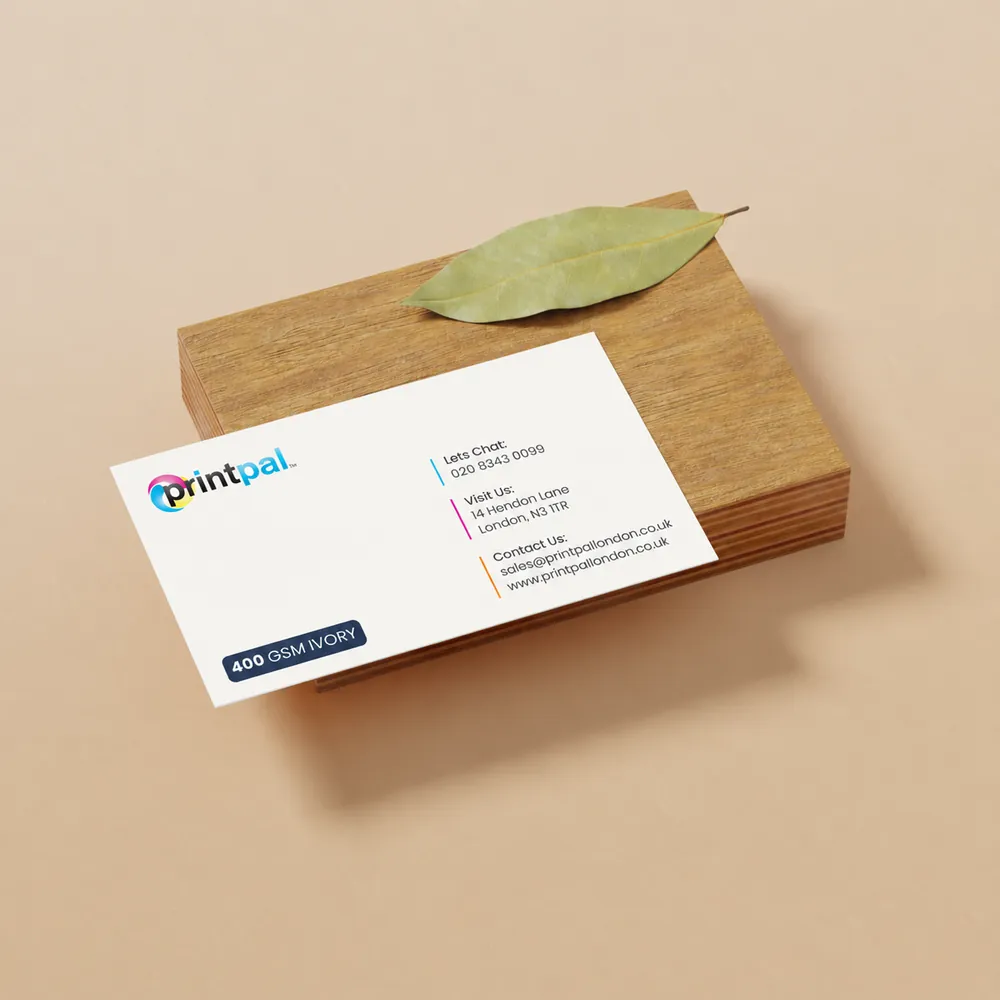 Printed business cards stacked on a wooden block
